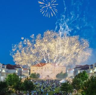 Fireworks exploding in the night sky over the campus commons Scharbauer Hall