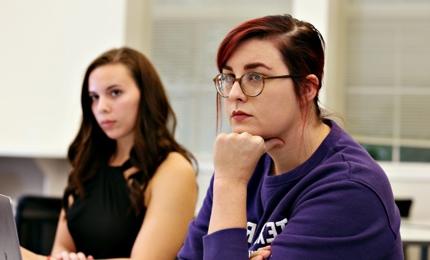 Two graduate students listen intently in an education class at TCU