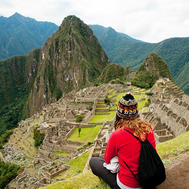 A young woman looks over the landscape of Machu Picchu (Getty)