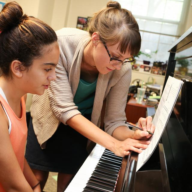 Teacher and student at piano